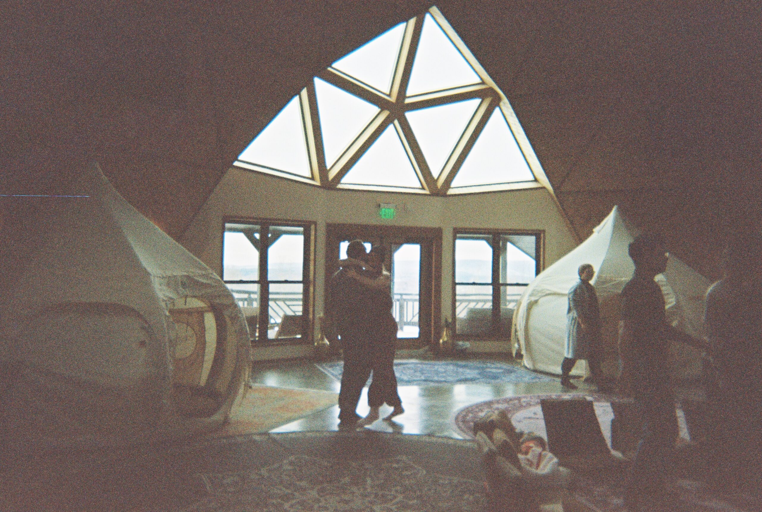 two people hug in a studio space for a feels wkndr