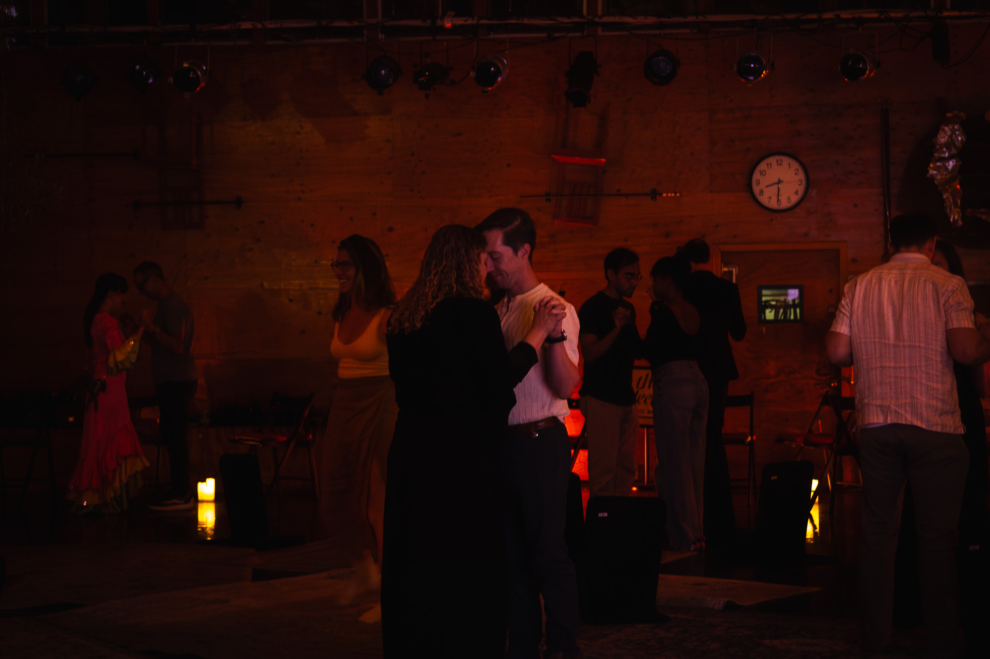 a wide shot of a 'feels' event, focusing on two people holding hands and touching foreheads